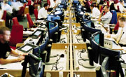 long row of monitors in office